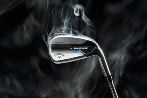 A Callaway Paradym Ai Smoke Iron in front of a black background with smoke coming off the iron