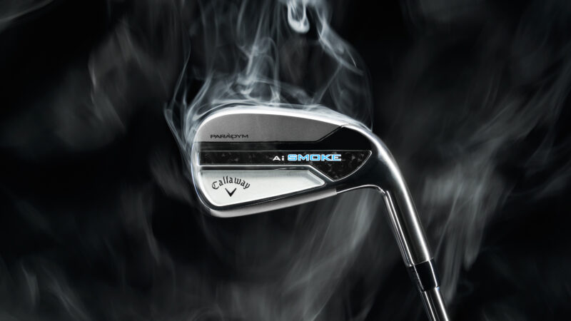 A Callaway Paradym Ai Smoke Iron in front of a black background with smoke coming off the iron