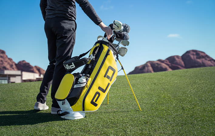 PING PLD Hoofer Stand Bag in yellow white and black on golf course